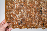 Rust brown wool rug placed under a coffee table