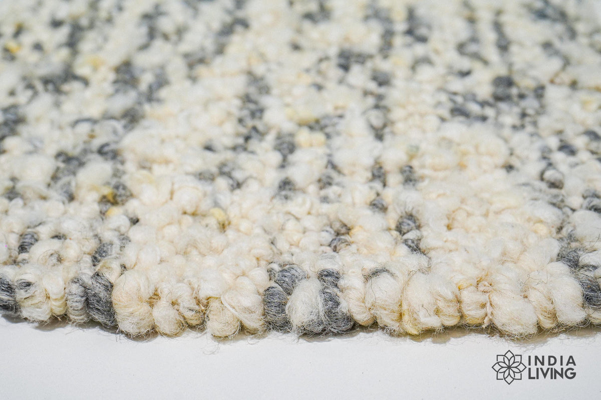 Corner detail of ivory grey textured wool rug