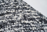 Corner detail of ivory black textured wool rug