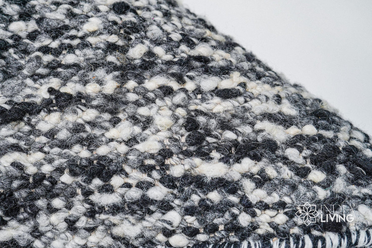 Corner detail of ivory black textured wool rug