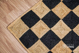 Full view of checkered hand-braided jute runner on floor
