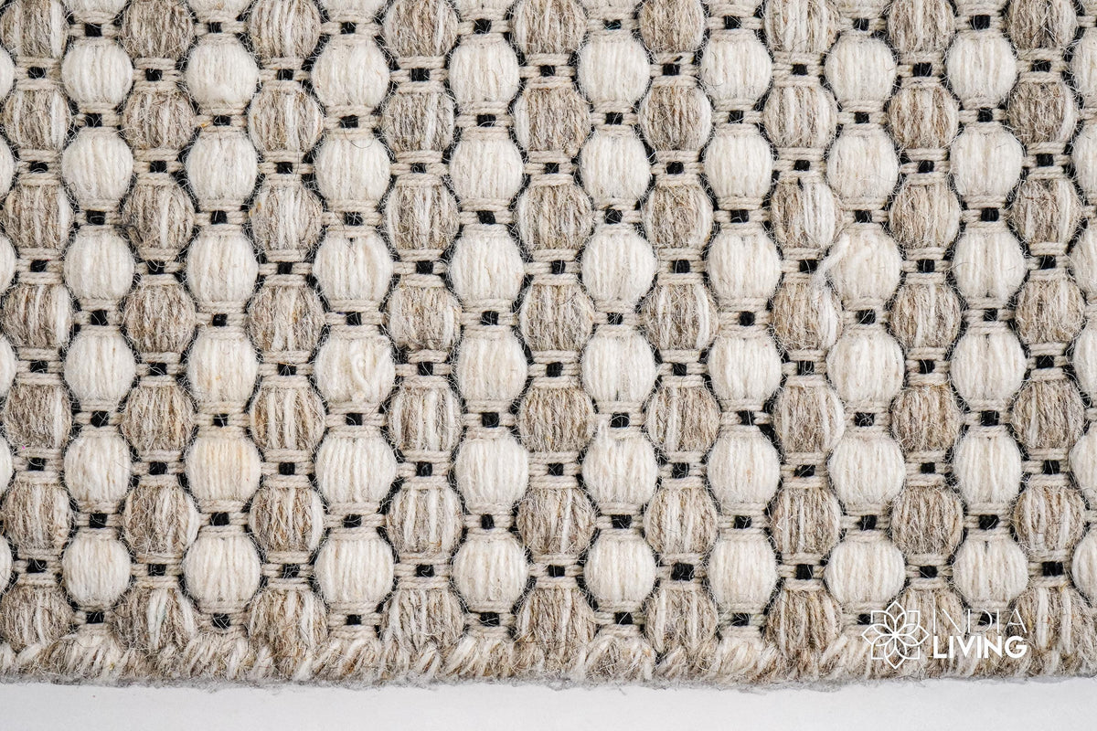 Beige cream wool rug in a boho-styled entryway