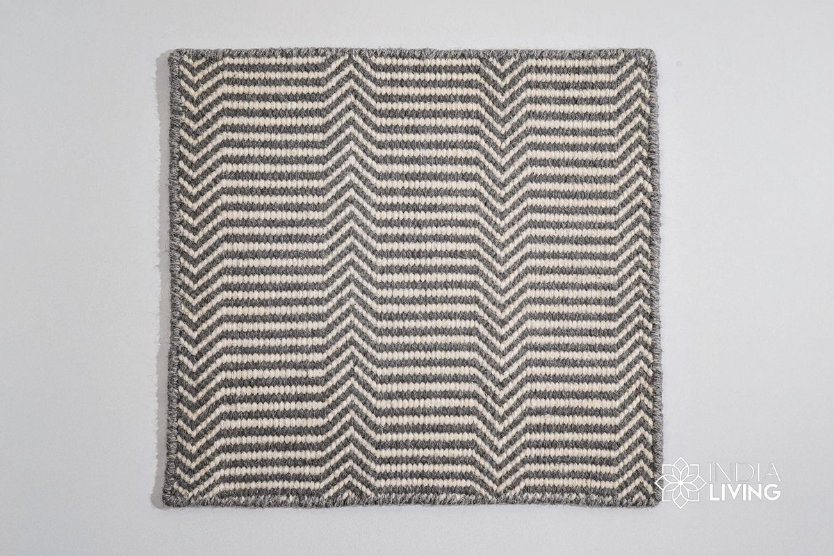 Corner detail of light grey chevron wool rug