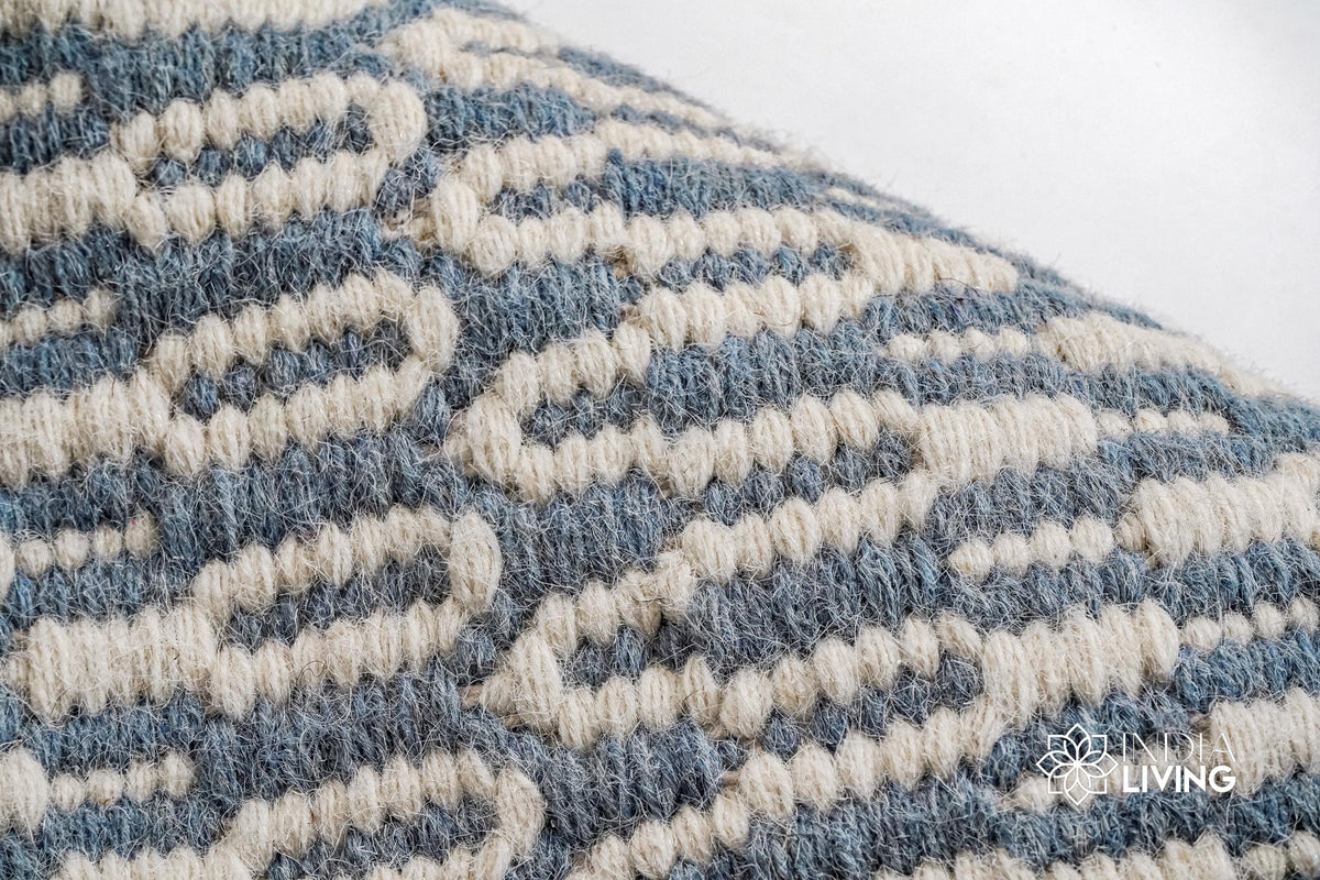 Bluish grey wool rug placed under a coffee table