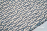 Bluish grey wool rug in a modern bedroom