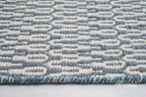 Full view of bluish grey geometric wool rug on floor