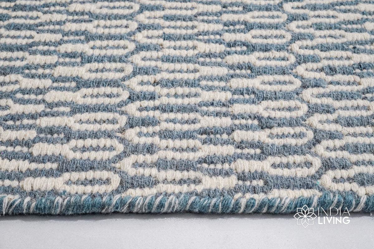 Full view of bluish grey geometric wool rug on floor