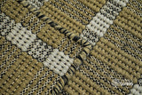 Olive green wool rug styled in a modern living room