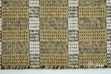 Olive green wool rug texture close-up showing handwoven weave