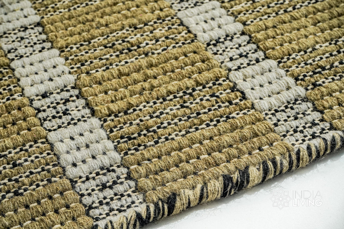 Top-down view of olive green geometric striped wool rug