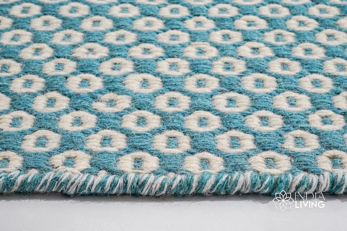 Top-down view of turquoise blue honeycomb geometric rug