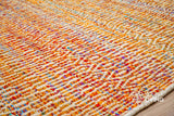 Top-down view of multi blend orange geometric rug