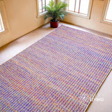 Purple multi blend wool rug styled in a living room