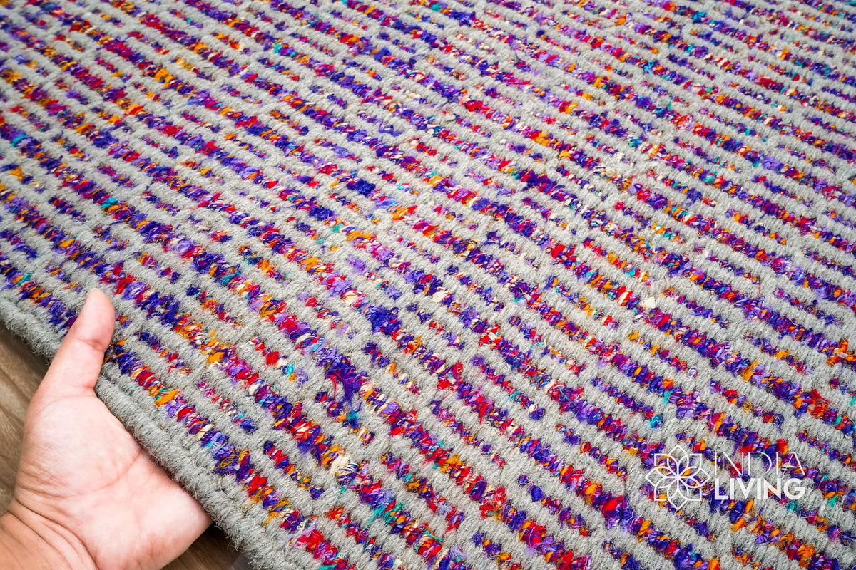 Purple flatweave rug in a bedroom setting