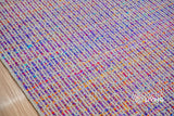 Top-down view of purple multi blend geometric rug