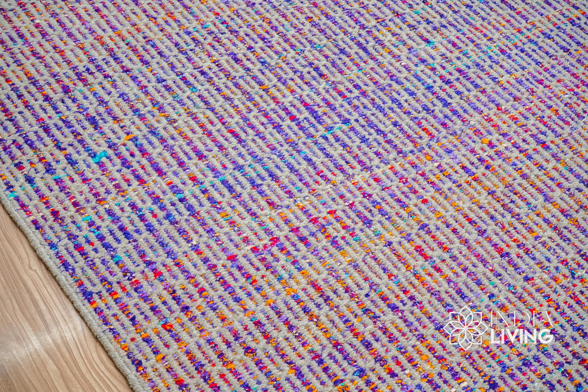 Top-down view of purple multi blend geometric rug