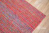 Multi blend red wool rug texture close-up showing handwoven weave