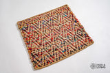 Top-down view of natural multicolour diamond jute rug