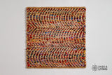 Top-down view of natural multicolour ripple jute rug