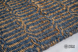 Close-up of ribbed geometric weave texture on jute wool rug