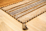 Corner detail of handwoven brown kilim rug