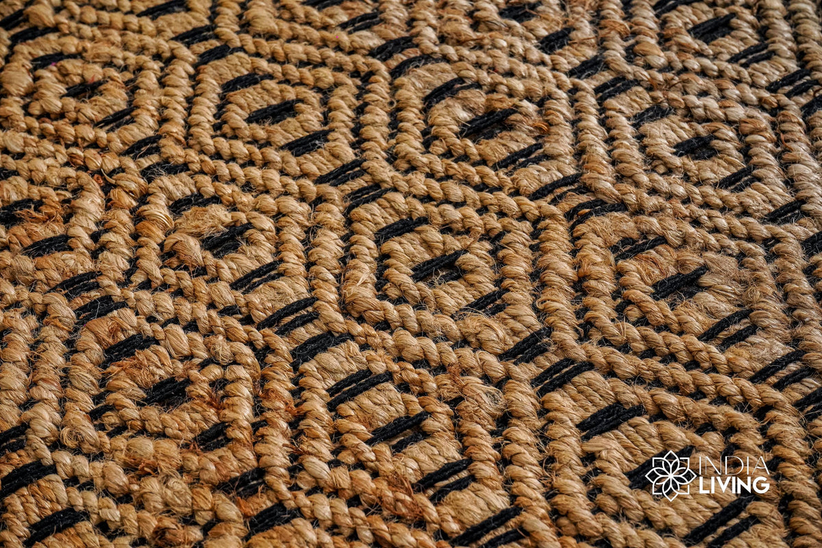 Handwoven jute diamond rug shown in a bedroom setting