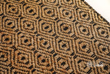 Natural jute diamond rug styled in a boho living room