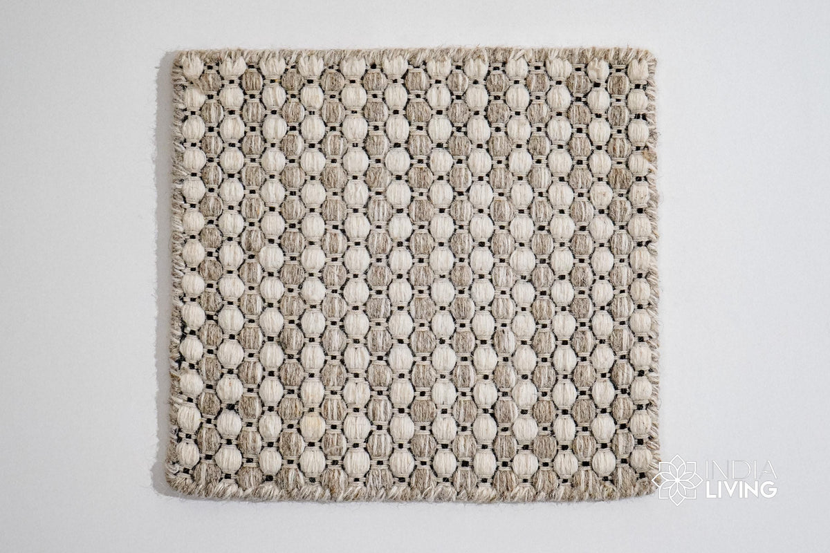 Corner detail of beige cream ribbed wool rug