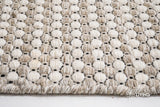 Beige cream wool rug placed under a coffee table