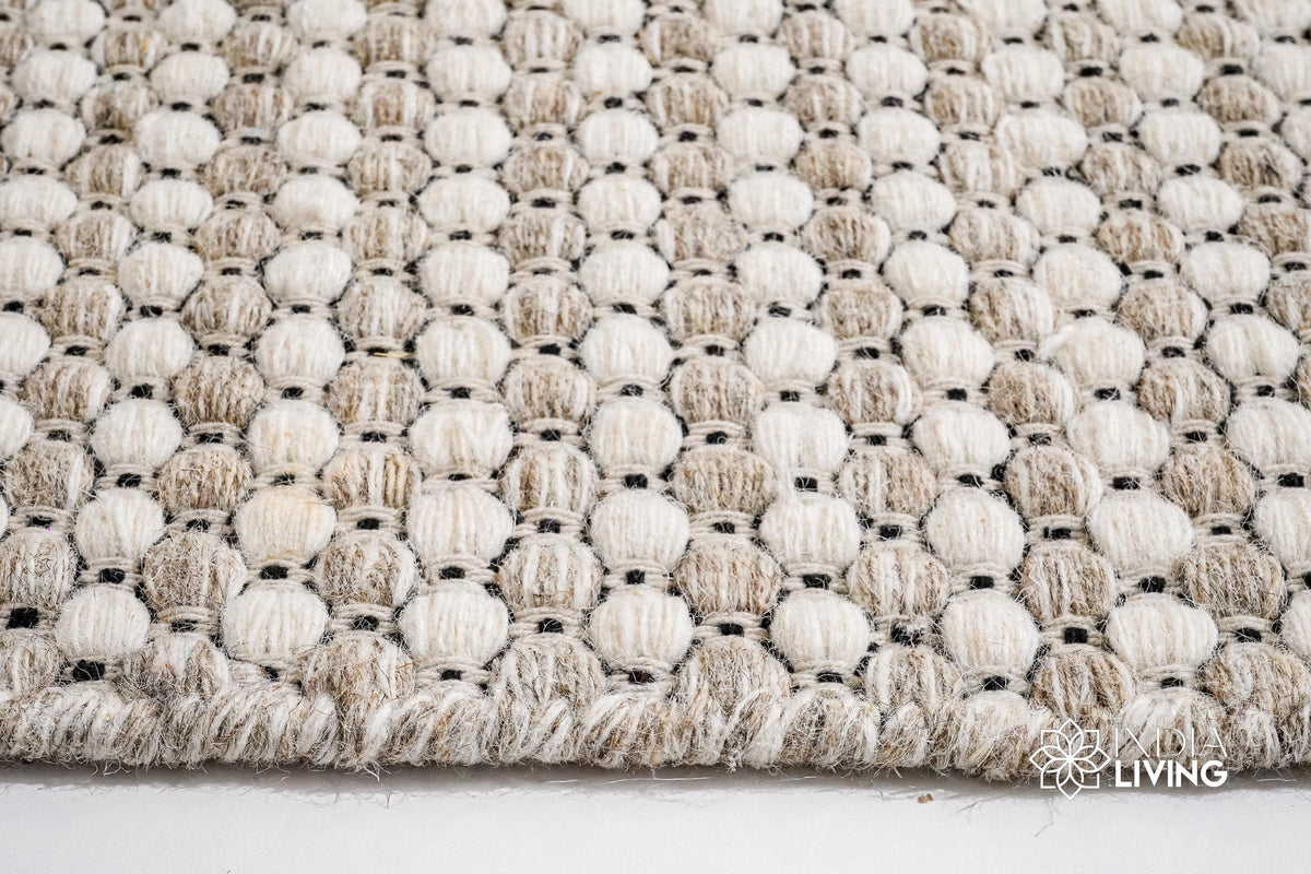Beige cream wool rug placed under a coffee table