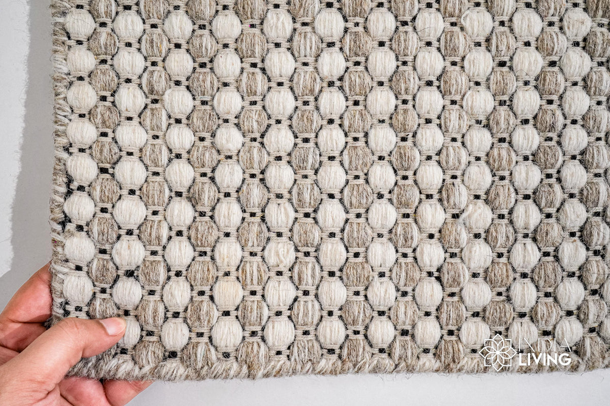 Beige cream wool rug in a Scandinavian bedroom