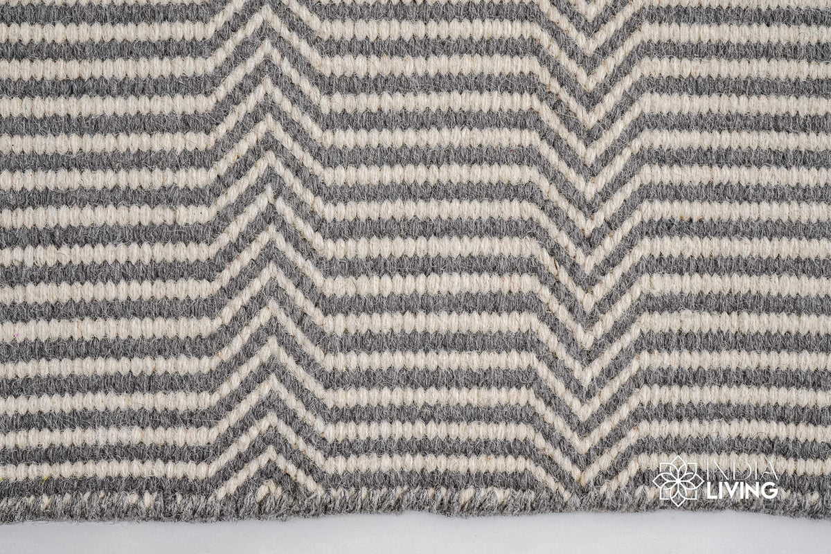 Full view of light grey chevron wool rug on floor