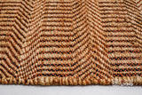 Orange chevron jute rug styled in a boho living room