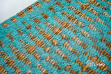 Turquoise blue rug corner detail showing edge binding