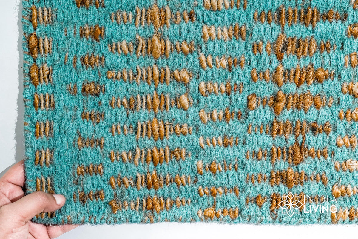 Turquoise blue geometric flatweave rug styled in a living room
