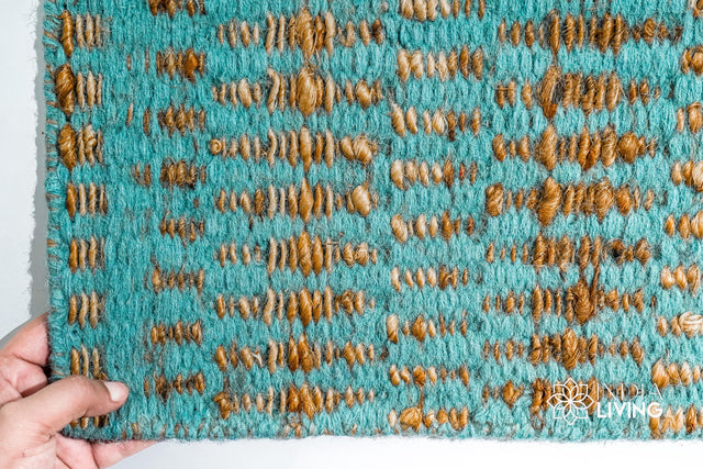Turquoise blue geometric flatweave rug styled in a living room