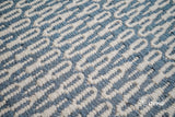 Bluish grey flatweave wool rug styled in a living room