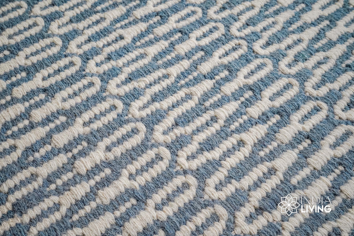 Bluish grey flatweave wool rug styled in a living room