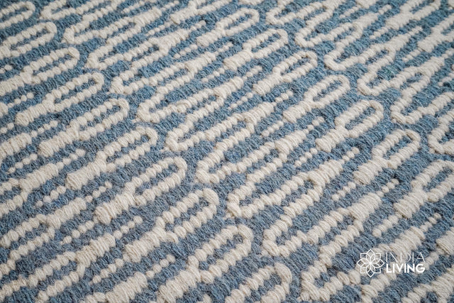 Bluish grey flatweave wool rug styled in a living room