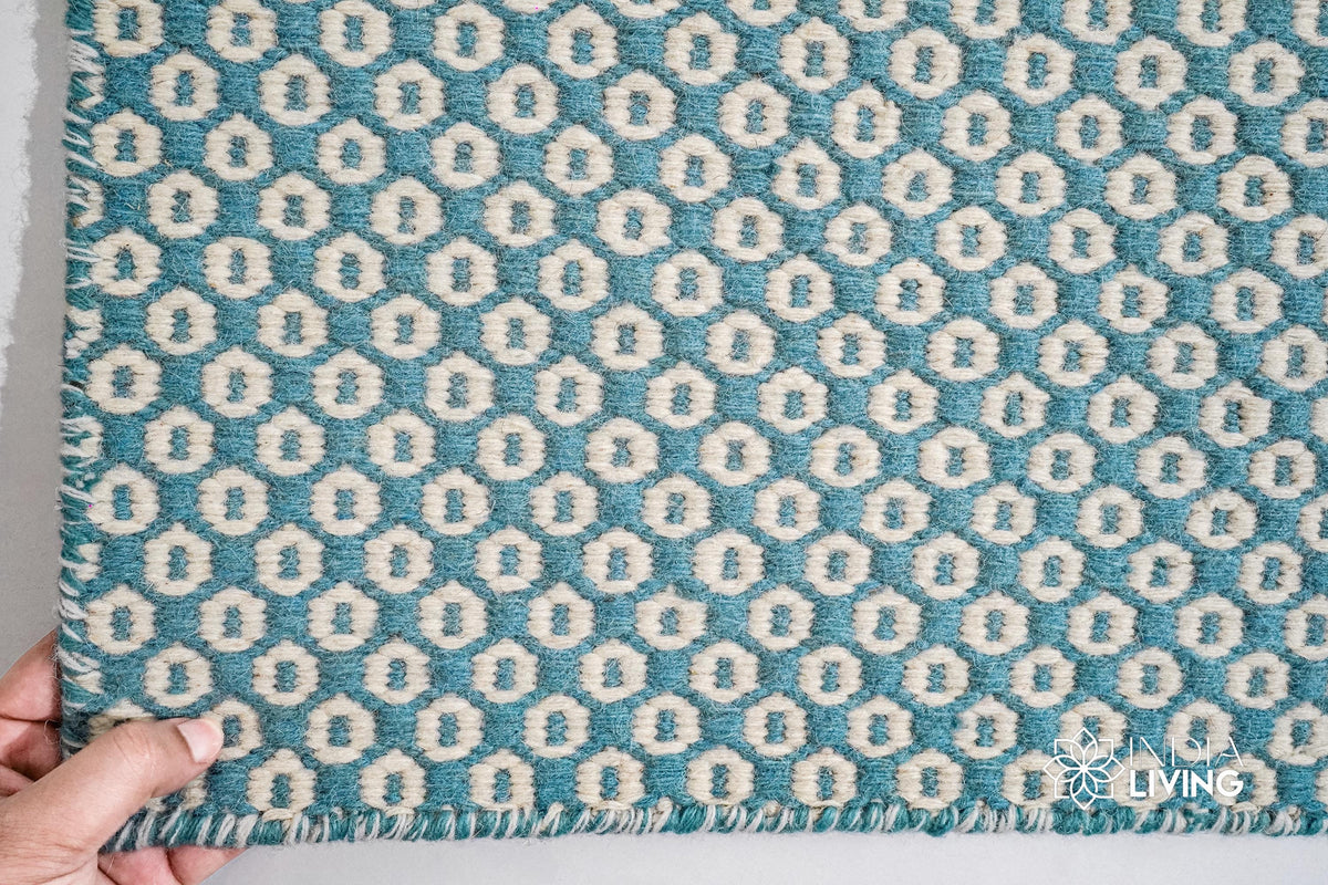 Turquoise blue wool rug under a coffee table
