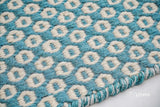 Turquoise blue wool rug styled in a modern living room