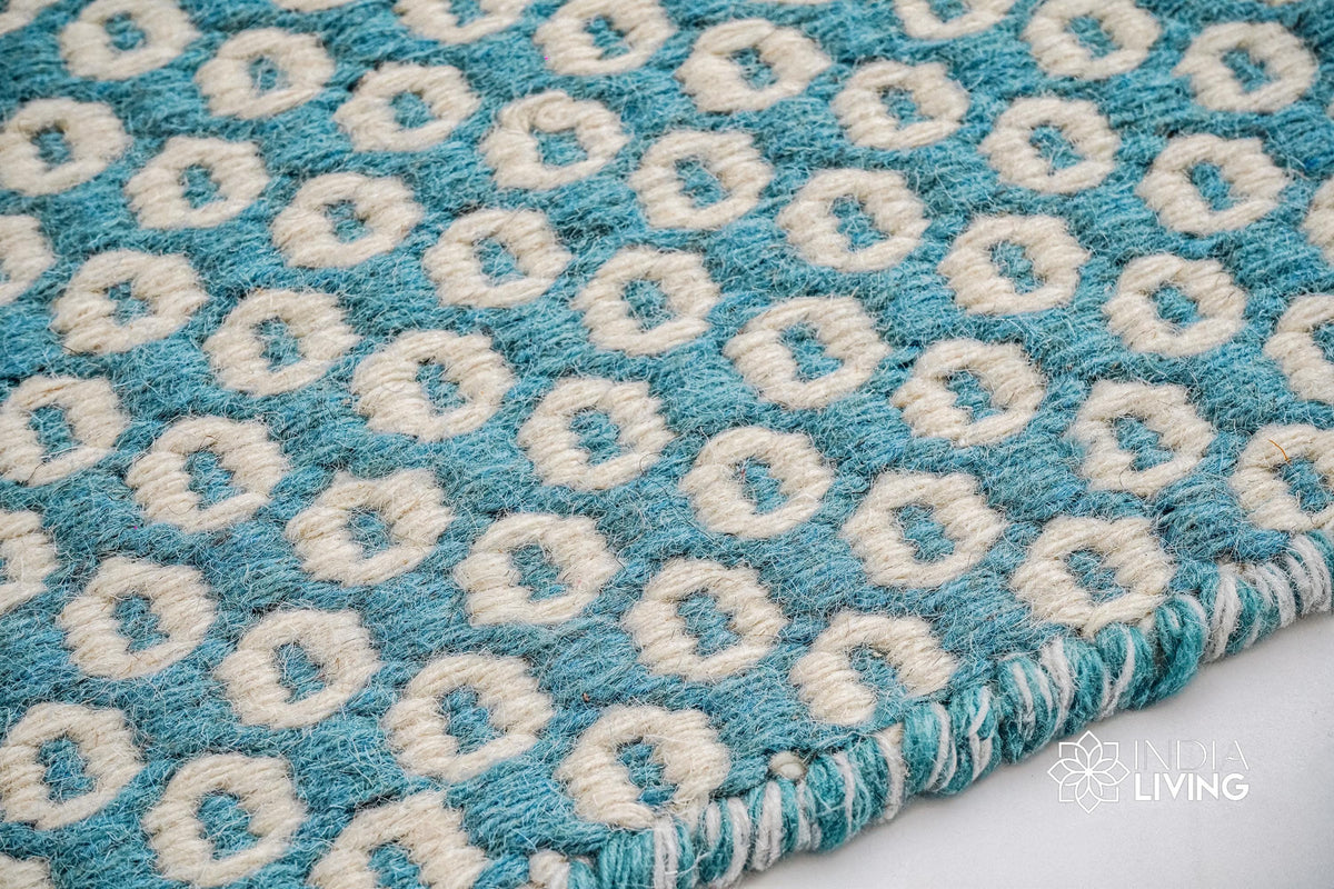 Turquoise blue wool rug styled in a modern living room