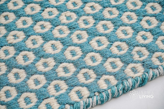 Turquoise blue wool rug styled in a modern living room