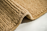 Tan beige sumac braided wool rug close-up woven texture