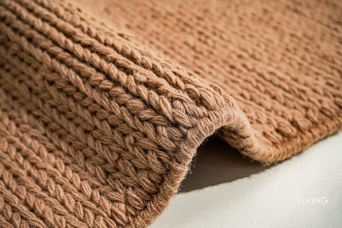 Tan brown sumac braided wool rug close-up knit texture