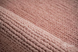 Light pink sumac braided wool rug close-up knit texture