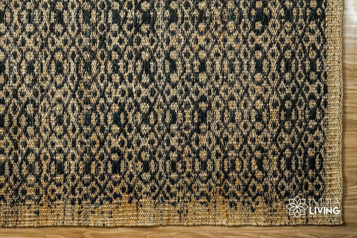 Natural jute rug rolled to show reversible weave