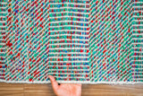 Multi blend teal flatweave rug in a bright bedroom