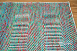 Multi blend teal wool rug under a coffee table
