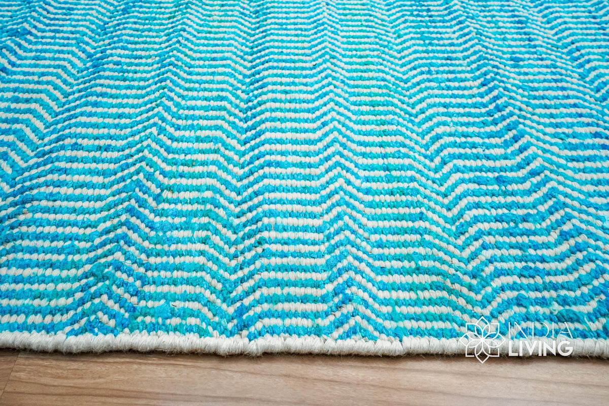 Top-down view of aqua blue chevron geometric rug